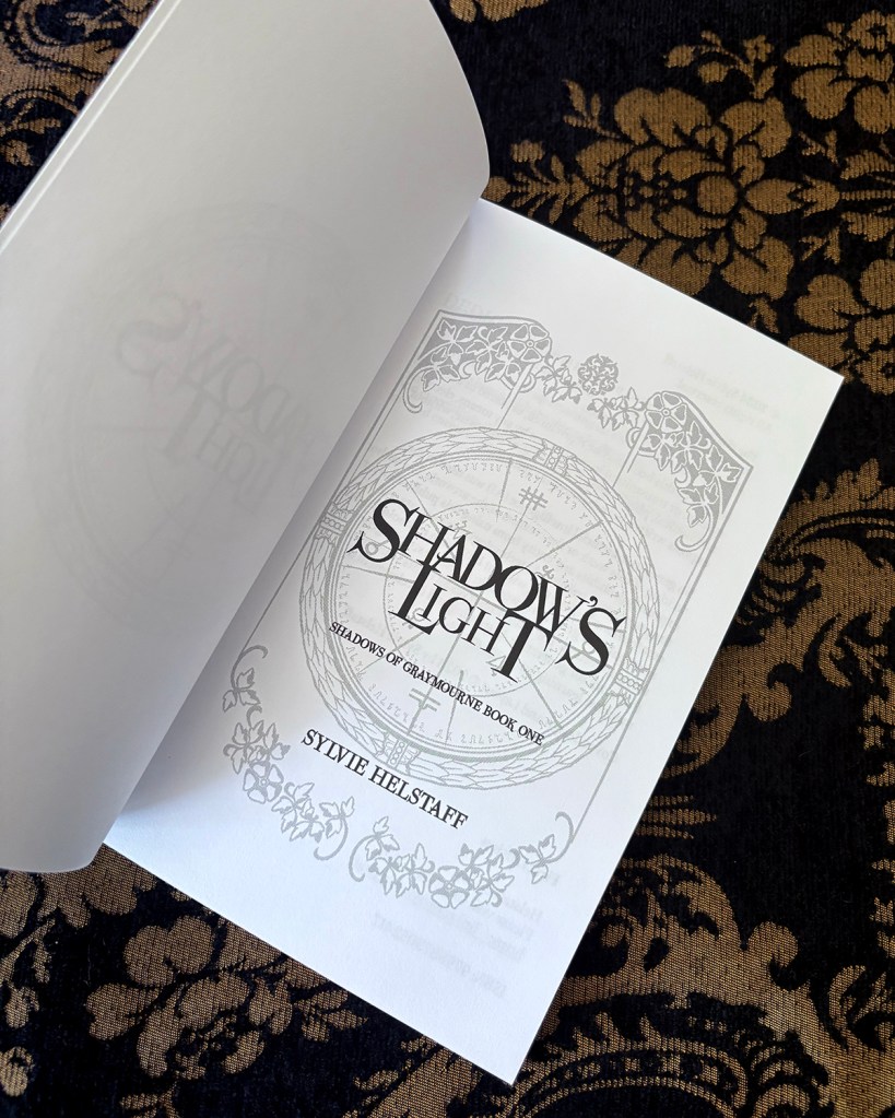 Title Page of Shadow's Light Paperback shows the title and author name on a filigree background with a summoning sigil in the center